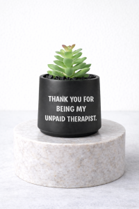 Matte black succulent jar on a marble pedestal with the message “Thank you for being my unpaid therapist”