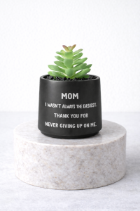 Matte black succulent message jar on a marble pedestal with the quote “Mom I wasn’t always the easiest. Thank you for never giving up on me”