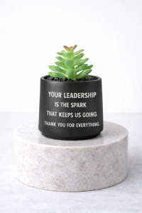 Matte black succulent message jar on a marble pedestal with the quote “Your leadership is the spark that keeps us going thank you for everything”